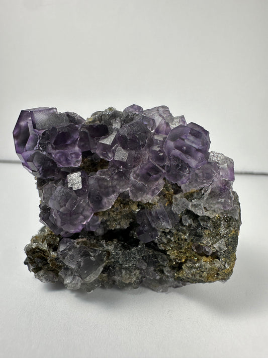 Purple Dodecahedral Fluorite with Calcite on matrix – Minerals