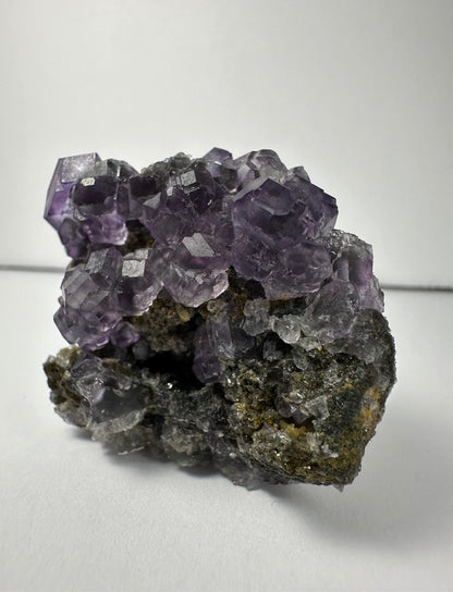 Purple Dodecahedral Fluorite with Calcite on matrix – Minerals