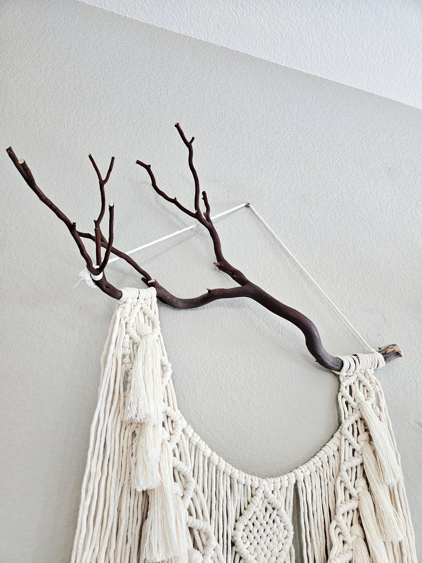 Macrame wall hanging on Manzanita branch.